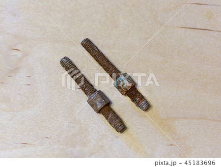 Rusty bolts from a water tap on wooden background 45183696