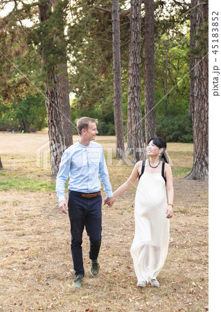 Man and woman mixed race walking and holding hands Man and woman mixed race walking and holding hands 45183852