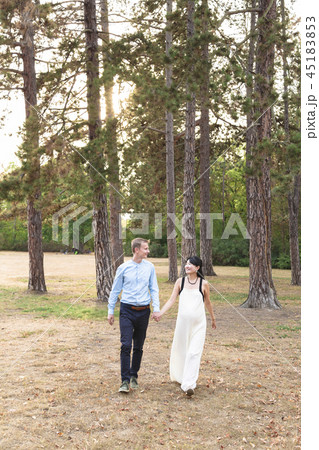 Man and woman mixed race walking and holding hands Man and woman mixed race walking and holding hands 45183853