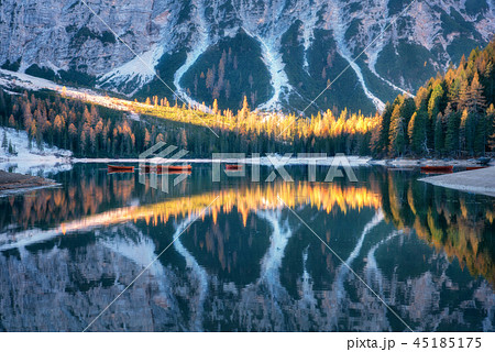Braies lake with reflection in water at sunrise Braies lake with reflection in water at sunrise 45185175