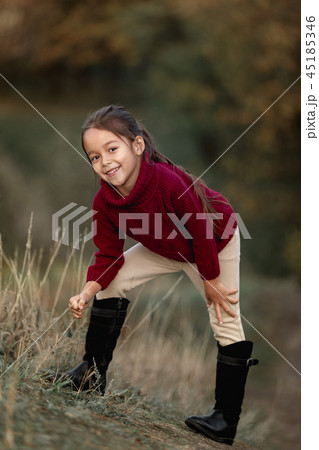 little girl playing with autumn fallen leaves little girl playing with autumn fallen leaves 45185346
