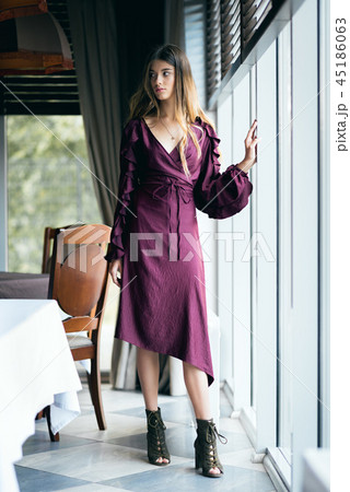 Girl in a dress in the interior of the cafe Girl in a dress in the interior of the cafe 45186063