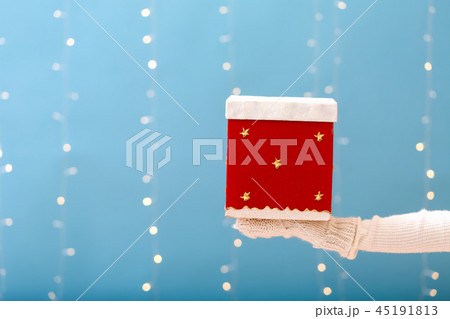 Person holding a Christmas gift box 45191813