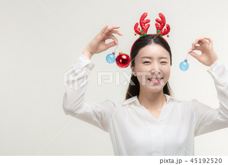 Christmas Day. Korea woman holding xmas props Christmas Day. Korea woman holding xmas props 45192520
