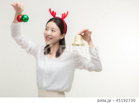 Christmas Day. Korea woman holding xmas props Christmas Day. Korea woman holding xmas props 45192730
