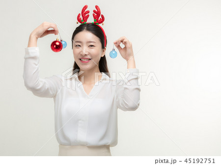 Christmas Day. Korea woman holding xmas props Christmas Day. Korea woman holding xmas props 45192751
