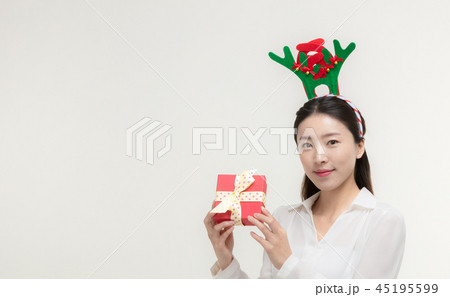 Christmas Day. Korea woman holding xmas props Christmas Day. Korea woman holding xmas props 45195599