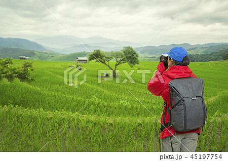 Young girl with backpack taking photo of amazing landscape sunse 45197754