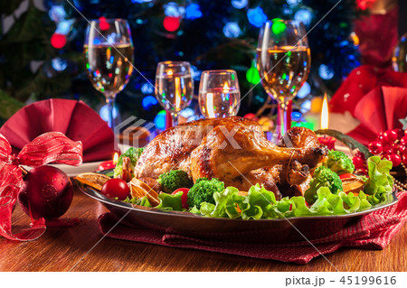 Baked or roasted whole chicken on Christmas table 45199616