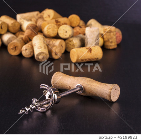The wine corks and corkscrew on black table The wine corks and corkscrew on black table 45199923
