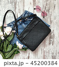 Black bag with shorts on a wooden background 45200384