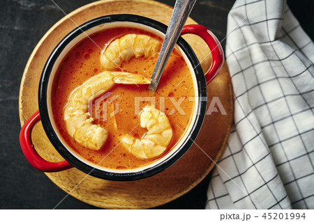 traditional Thai soup with shrimp in a red pot and a spoon 45201994