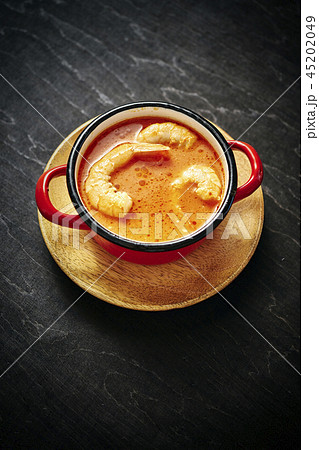 traditional Thai soup with shrimp in a red pot traditional Thai soup with shrimp in a red pot 45202049