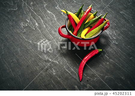 fresh and colorful chili peppers in a pot 45202311