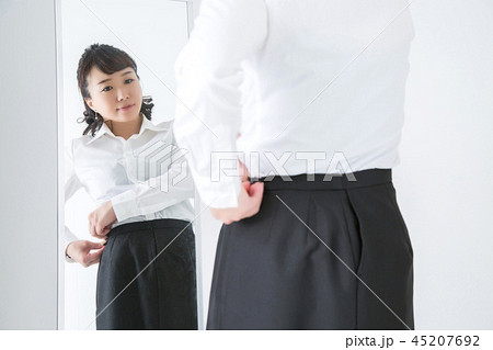 ファスナーを閉める女性 45207692