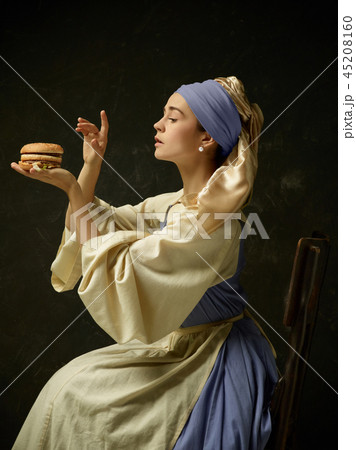 Medieval Woman in Historical Costume Wearing Corset Dress and Bonnet. Medieval Woman in Historical Costume Wearing Corset Dress and Bonnet. 45208160
