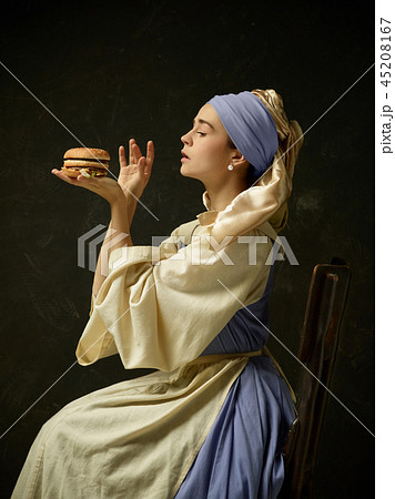 Medieval Woman in Historical Costume Wearing Corset Dress and Bonnet. Medieval Woman in Historical Costume Wearing Corset Dress and Bonnet. 45208167