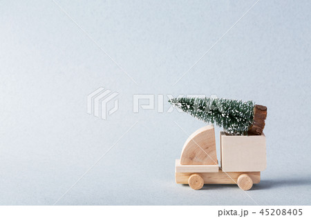 Miniature wooden truck with x-mas tree on is top 45208405