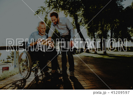 Smiling Man Hold Tablet. Outdoor Rehabilitation. Smiling Man Hold Tablet. Outdoor Rehabilitation. 45209597