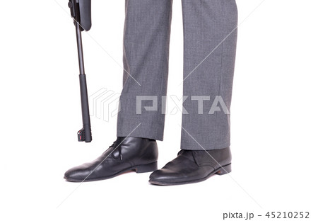 Businessman shooting himself in the foot  45210252