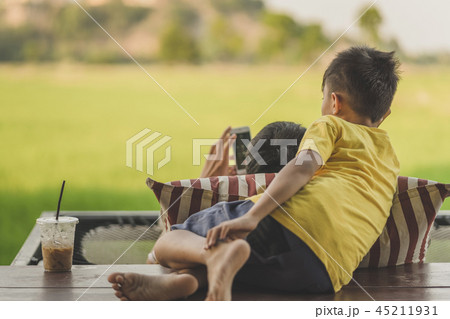 Dad and son relax on the balcony 45211931