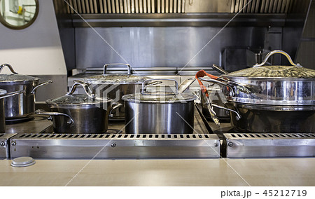 Pans and pots preparing food in a kitchen 45212719
