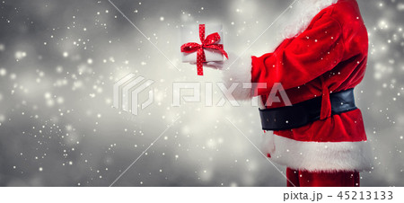 Santa holding a Christmas gift 45213133