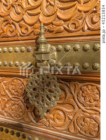 Detail bronze door caller of the Palace the Counts Cervellon close-up Detail bronze door caller of the Palace the Counts Cervellon close-up 45213834