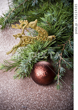 Evergreen fir tree branch, golden deer brown ball. Evergreen fir tree branch, golden deer brown ball. 45214385