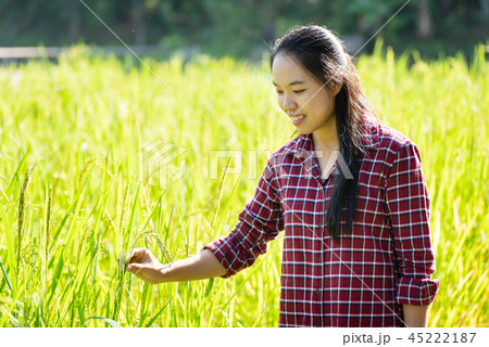 Asian young woman farmer in organic rice field 45222187