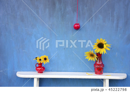 still-life with red vases, flowers and apple 45222798