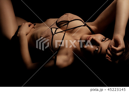 Young girl in sexy bra on the sofa in the dark Young girl in sexy bra on the sofa in the dark 45223145