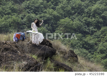Young woman ironing clothes Young woman ironing clothes 45223390