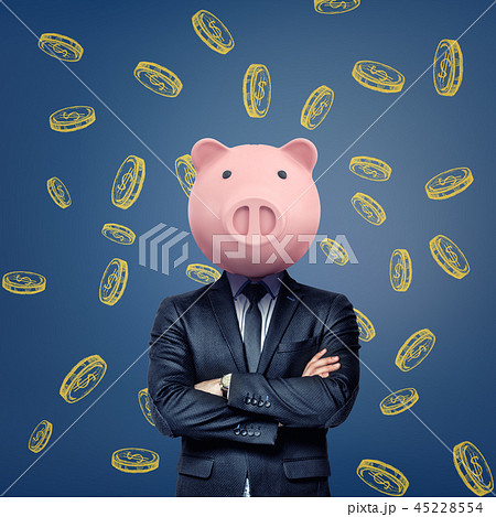 A businessman with folded arms stands wearing a pink pig mask on a background with chalk golden 45228554