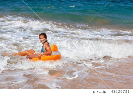 Happy girl have fun in sea surf on beach Happy girl have fun in sea surf on beach 45229731
