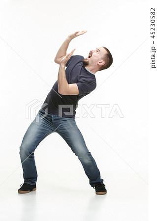 young cool man full body scared pose. young cool man full body scared pose. 45230582