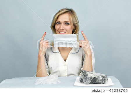 The girl lab technician puts on a mask. 45238796