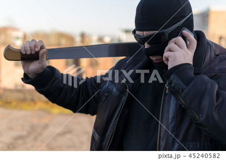bandit with a machete talking on the phone bandit with a machete talking on the phone 45240582