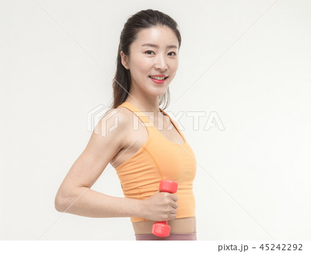 Korean woman exercising with dumbbells Korean woman exercising with dumbbells 45242292