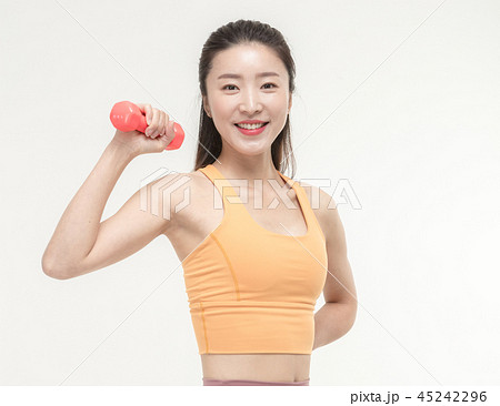 Korean woman exercising with dumbbells Korean woman exercising with dumbbells 45242296