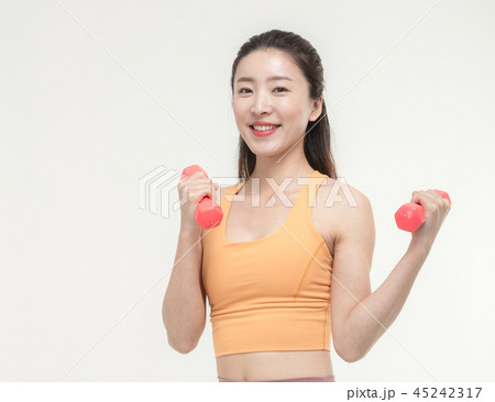 Korean woman exercising with dumbbells Korean woman exercising with dumbbells 45242317