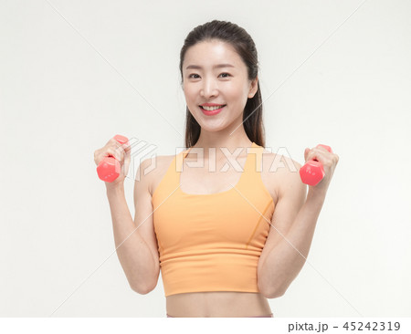 Korean woman exercising with dumbbells Korean woman exercising with dumbbells 45242319