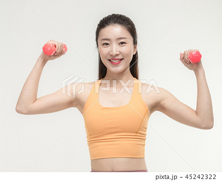 Korean woman exercising with dumbbells Korean woman exercising with dumbbells 45242322