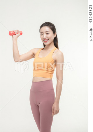 Korean woman exercising with dumbbells Korean woman exercising with dumbbells 45242325
