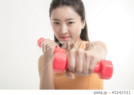 Korean woman exercising with dumbbells Korean woman exercising with dumbbells 45242331