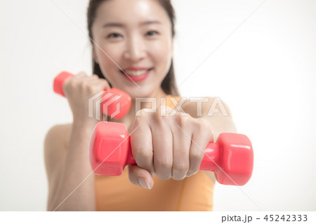 Korean woman exercising with dumbbells Korean woman exercising with dumbbells 45242333