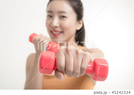 Korean woman exercising with dumbbells Korean woman exercising with dumbbells 45242334
