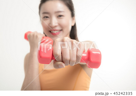 Korean woman exercising with dumbbells Korean woman exercising with dumbbells 45242335