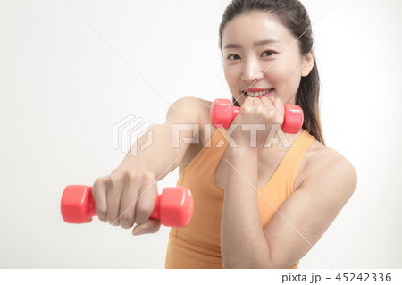 Korean woman exercising with dumbbells Korean woman exercising with dumbbells 45242336