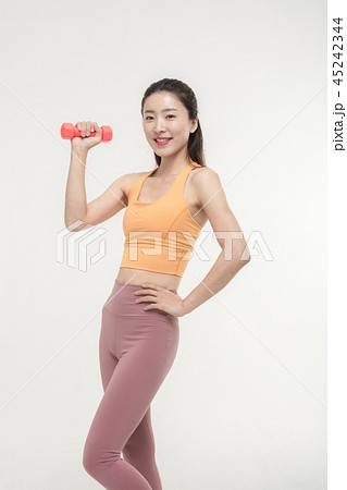 Korean woman exercising with dumbbells Korean woman exercising with dumbbells 45242344